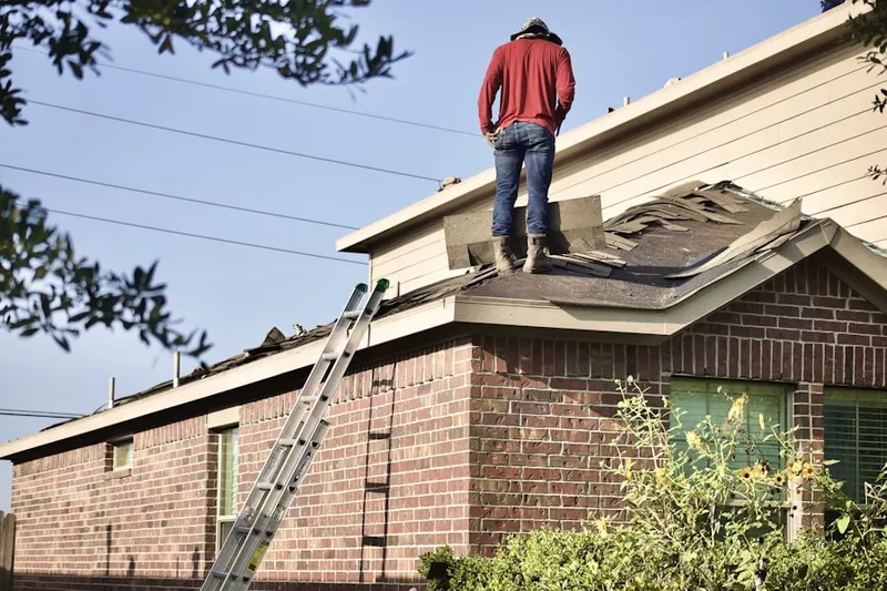 Professional roofer working on a residential roof in Sayers